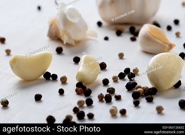 natural healthy garlic on white wooden table with condiments
