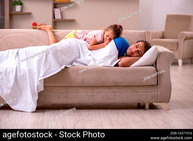 Young man with his small daughter at home