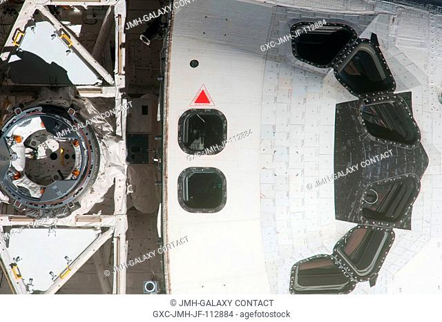This high angle, partial view of the space shuttle Endeavour's crew cabin and docking mechanism was provided by an Expedition 27 crew member during a survey of...