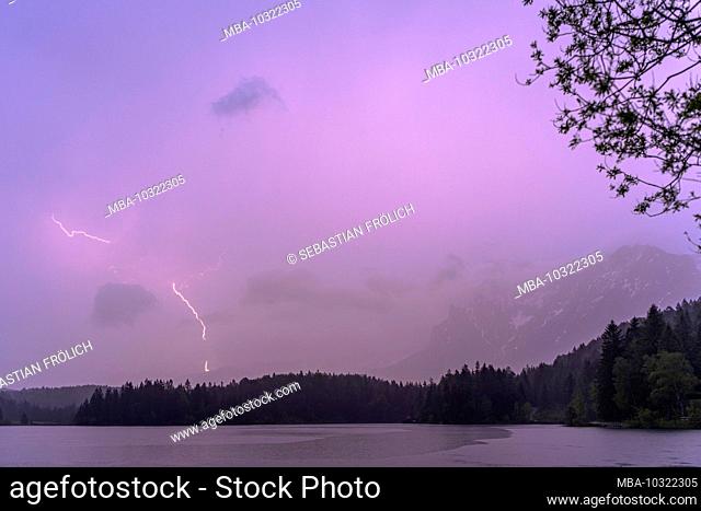 Thunderstorm and lightning strike in the Karwendel, seen at Lautersee near Mittenwald