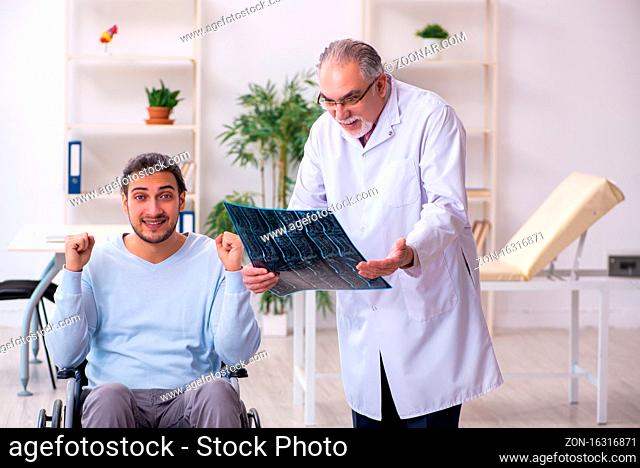 Man in wheel-chair and old doctor radiologist