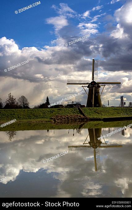 Windmill De Lelie near the Dutch village Puttershoek reflecting in a pond