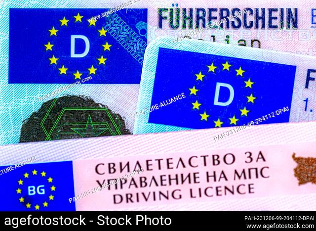 06 December 2023, Bremen: ILLUSTRATION - A Bulgarian and two German driving licenses lie on a table. On December 7, the EU Parliament's Transport Committee will...