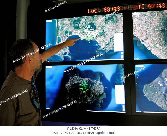 Geologist Roberto Isaia points at satellite photos of the Gulf of Naples at the volcano observatory of the National Institute for Geophysics and Volcanology...