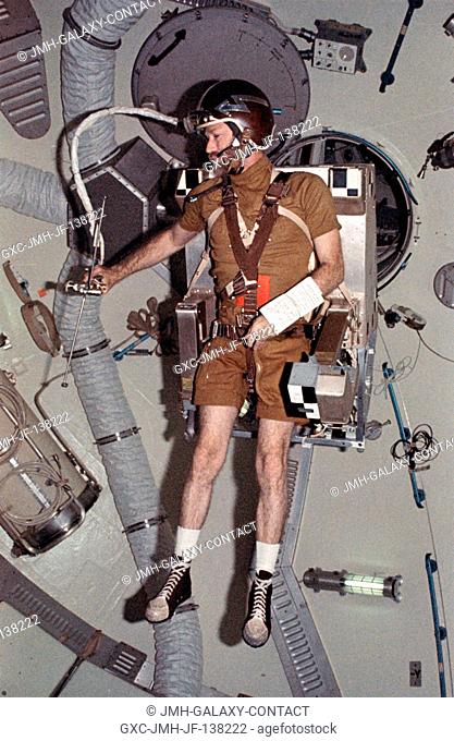 Astronaut Gerald P. Carr, commander of the Skylab 4 mission, flies the Astronaut Maneuvering Equipment M509 Experiment in the forward compartment of the Orbital...