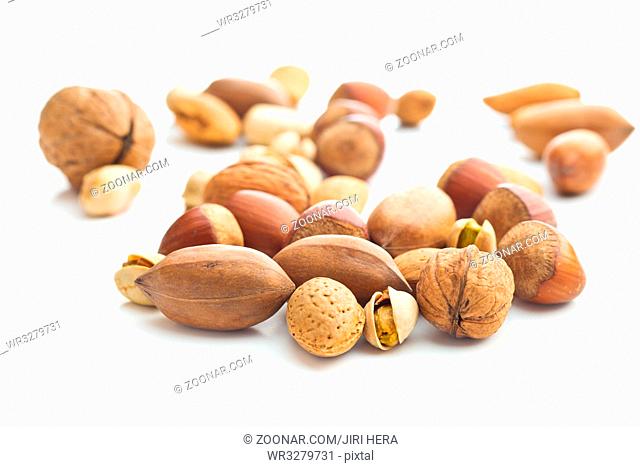 Different types of nuts in the nutshell. Hazelnuts, walnuts, almonds, pecan nuts and pistachio nuts isolated on white background
