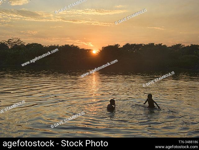 Kids swimming in the Rio Magdalena at sunset, Santa Cruz de Mompox, Bolivar, Colombia