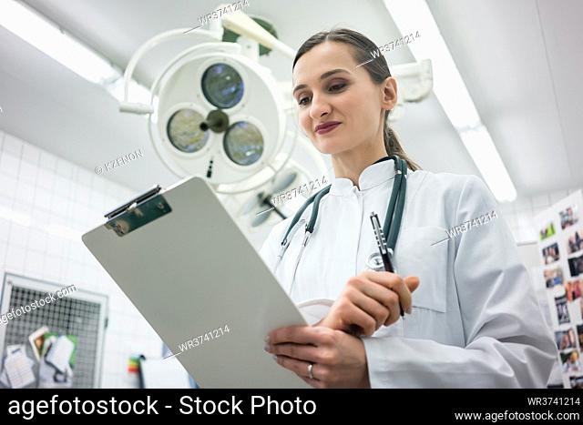Doctor in Clinic Operation Theater with clipboard in hand