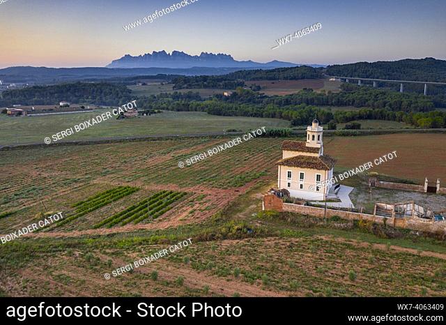 Montserrat mountain and Torre LluviÃ  de Manresa, surrounded by vineyards of the DO Pla de Bages, in an aerial view of a summer sunrise (Barcelona province