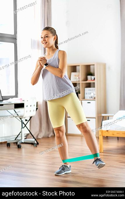 woman exercising with resistance band at home