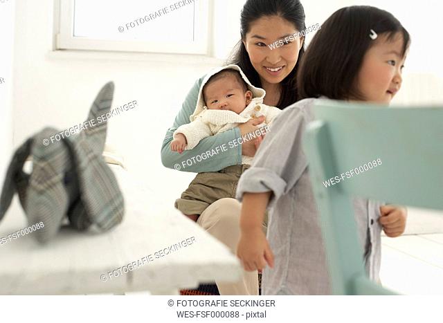 Asian mother with toddler and baby