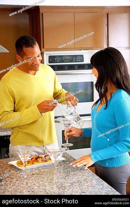 Man mixing a drink in a kitchen