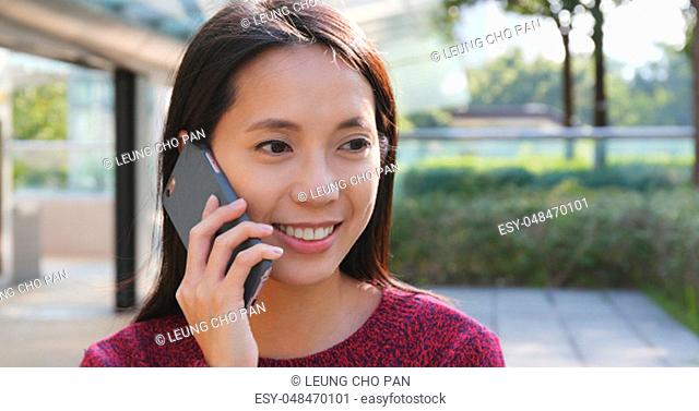 Woman talk to cellphone at outdoor