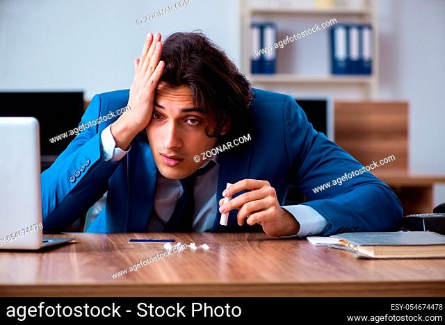 The young man having problems with narcotics at workplace