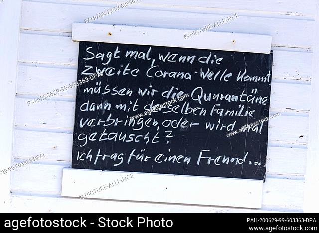 05 June 2020, Mecklenburg-Western Pomerania, Hiddensee: On Hiddensee, so-called smile boards hang in various places. On the beach of Vitte lifeguards have put...
