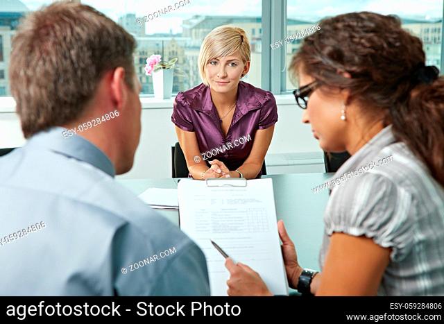 Attractive woman applicant hoping in good resuts after job interview. Over the shoulder view