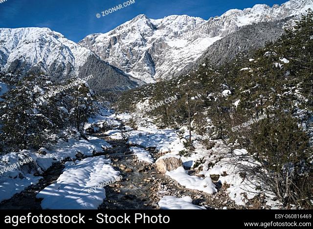 Sunny winter landscape in deep snow and forest with mountain river in Austrian Alps, Mieming, Tyrol, Austria
