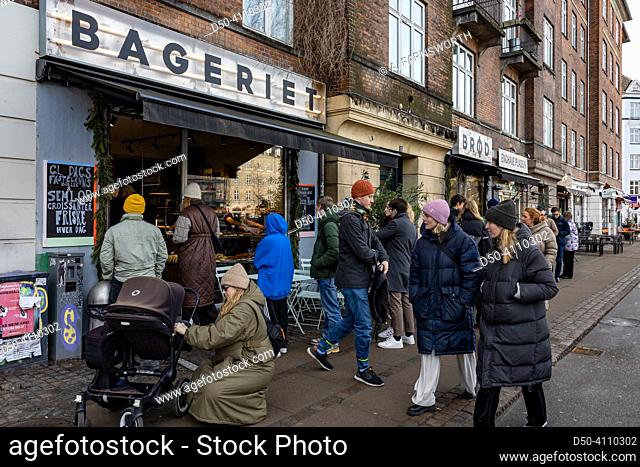Copenhagen, Denmark People lining up at a bakery to buy fresh bread and semlor, a sweet lent treat, also called
