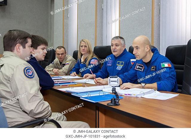 At their Cosmonaut Hotel crew quarters in Baikonur, Kazakhstan, the backup crew members for the Expedition 34 mission review flight plans with crew trainers Dec
