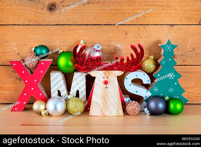 A wooden reindeer with xmas text in a wooden box Christmas symbols decoration