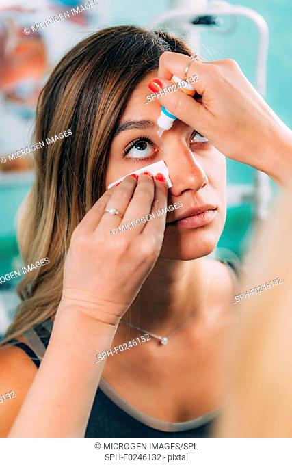 Ophthalmologist applying eye drops