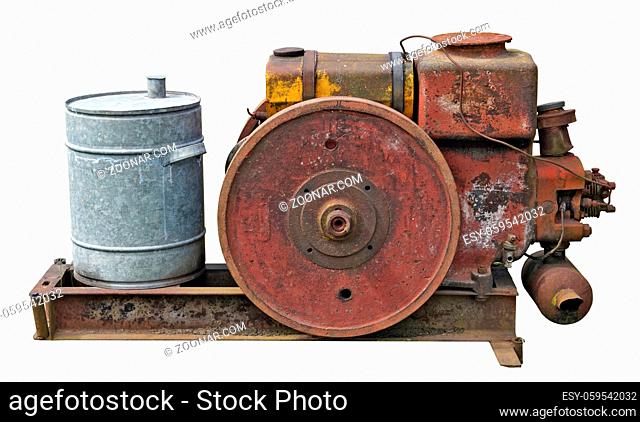 Retro small tractors diesel engine whith wheel. The metal equipment is made more than hundred years ago. Isolated on white