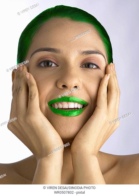 Girl painted hair and lips showing green environment MR