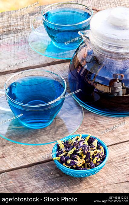 The set of two transparent cups and a teapot with freshly brewed blue flowers anchan tea