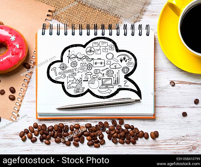 Top view of wooden table and notepad with sketches