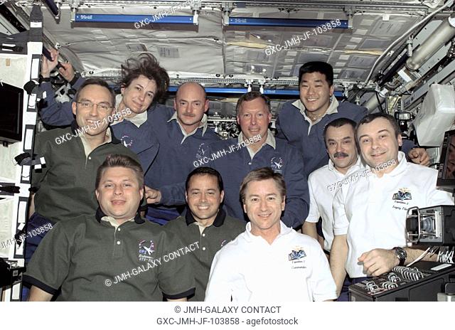 The Expedition Four (green shirts), STS-108 (blue shirts), and Expediton Three (white shirts) crews assemble for a group photo in the Destiny laboratory on the...