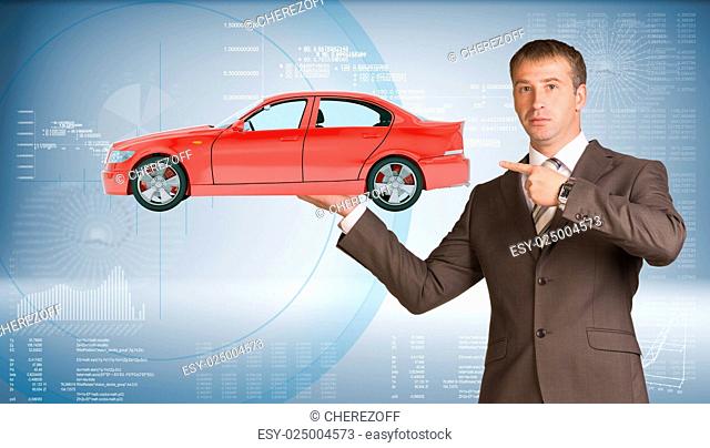 Businessman holding red car and looking at camera on abstract blue background