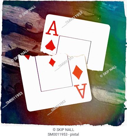 The ace of diamonds from and deck of playing cards torn in half