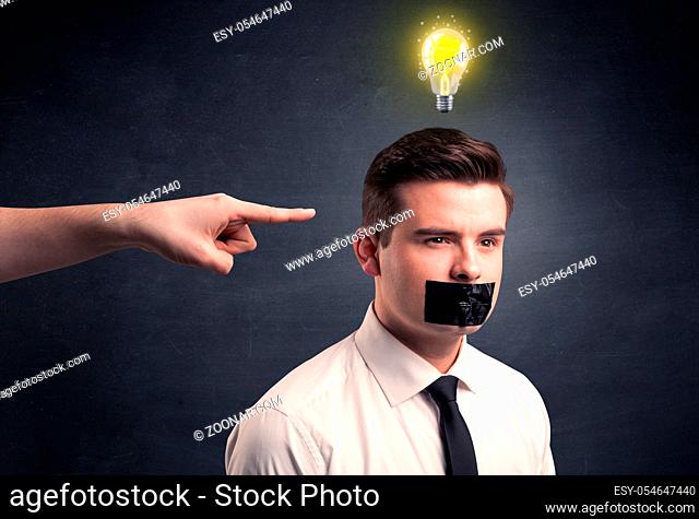 Caucasian hand pointing at businessman with a lightbulb above his head
