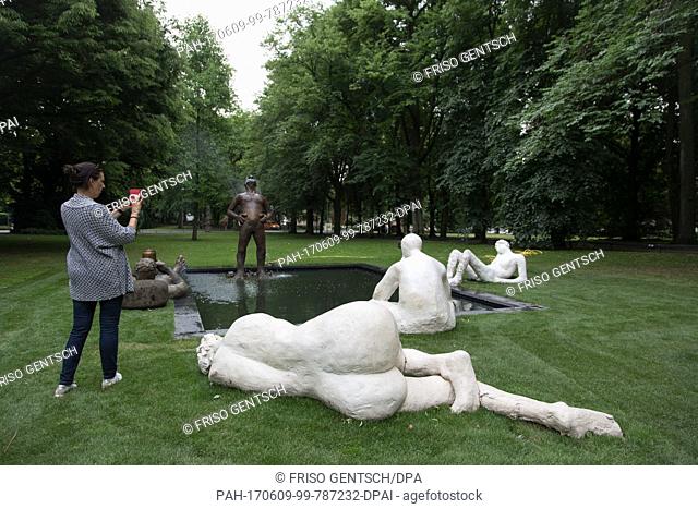 A woman takes pictures at the installation «Sketch for a Fountain» by Nicole Eisenmann in Muenster, Germany, 09 June 2017