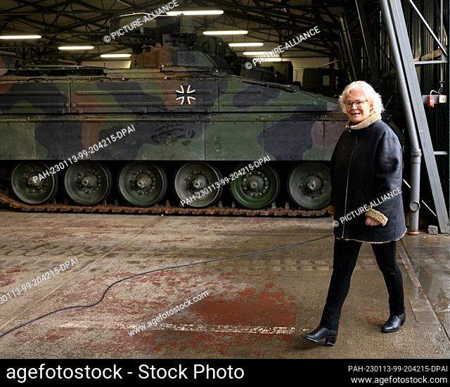 12 January 2023, Saxony, Marienberg: Christine Lambrecht (SPD), Federal Minister of Defense walks along in front of an infantry fighting vehicle Marder during a...