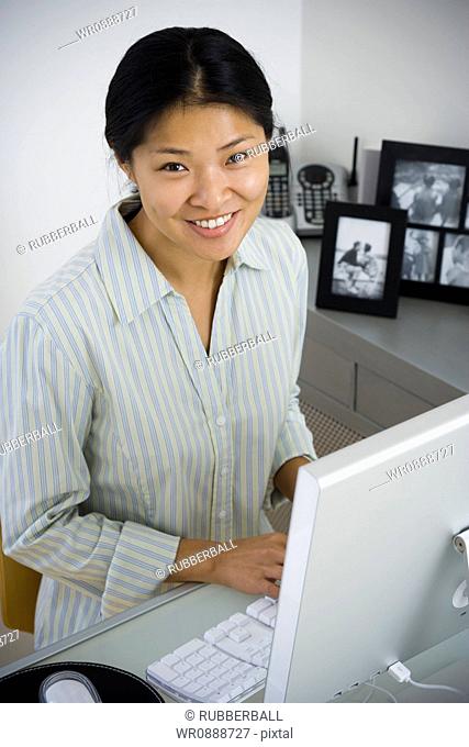 Portrait of a mid adult woman sitting in front of a computer