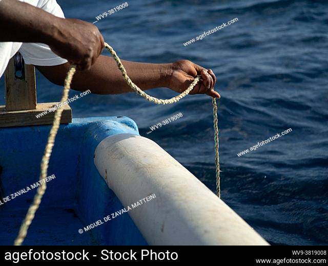 Fisherman Hands PICK UP the rope of the fishing cage, Dominican Republic