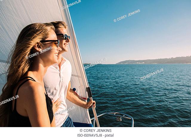 Couple enjoying view on sailboat, San Diego Bay, California, USA