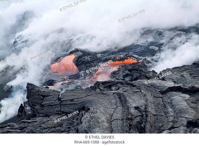 Steam plumes from hot lava flowing onto beach and into the ocean, Kilauea Volcano, Hawaii Volcanoes National Park, UNESCO World Heritage Site
