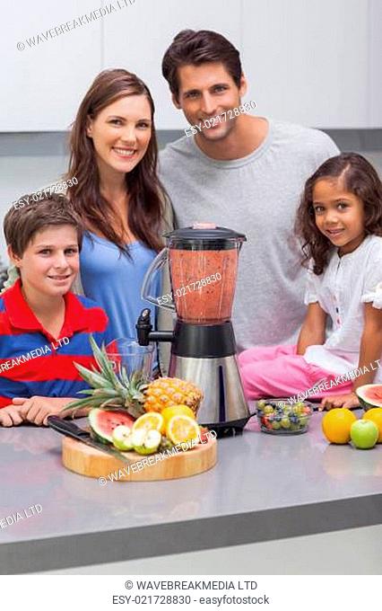 Smiling family using a blender together
