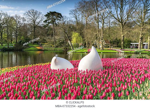 Bulblike sculpture and pink tulips at Keukenhof Gardens. Lisse, South Holland province, Netherlands