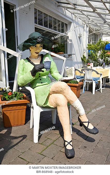 Woman made of paper, sitting in front of a restaurant, Bad Ems, Rhineland-Palatinate, Germany, Europe