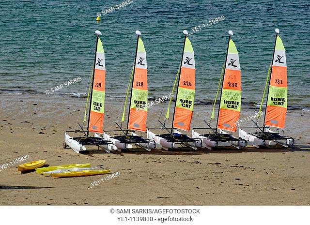 Five catamarans and some kayaks parked on the beach, Brittany, France
