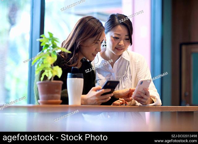 Two women having meeting in café