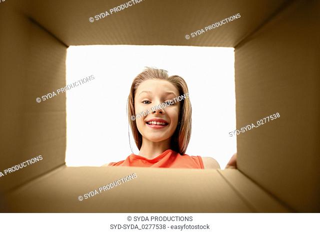 happy surprised girl looking into gift box