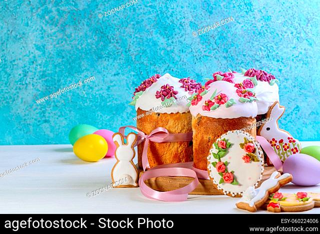 Happy Easter concept, spring greeting card, composition with Easter cake, gingerbread and eggs on white wooden table