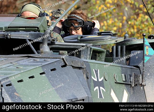 09 November 2021, Saxony-Anhalt, Letzlingen: Federal Minister of Defence Annegret Kramp-Karrenbauer sits with protective equipment on a command tank of the tank...