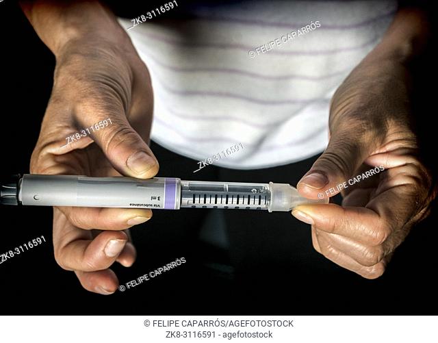 Woman examining treatment of insulin, conceptual image