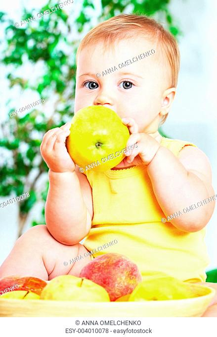 Little baby eating apple