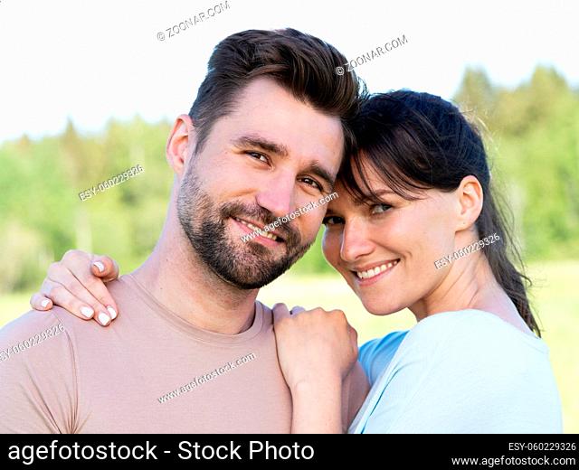 Portrait of a smiling mid adult couple in summer park